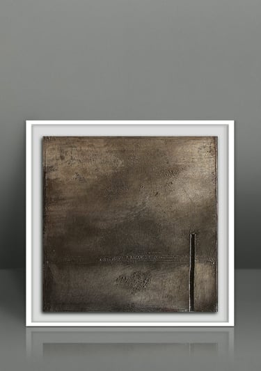 Minimalist bronze textured abstract wall art in a modern white frame against a grey background.