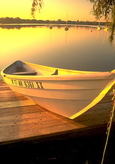 a boat on a dock with a boat in the water