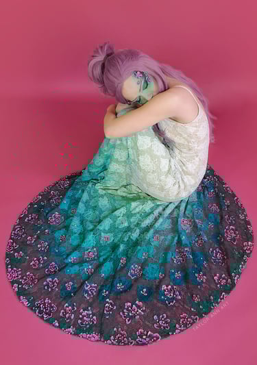 Wedding Dress with a teal green dip dye and 3-d painted pink flowers around the hem on a model