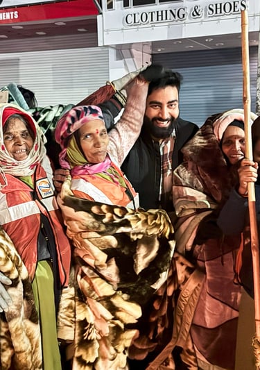 Community blanket drive with volunteers distributing warm blankets to people in need on a street