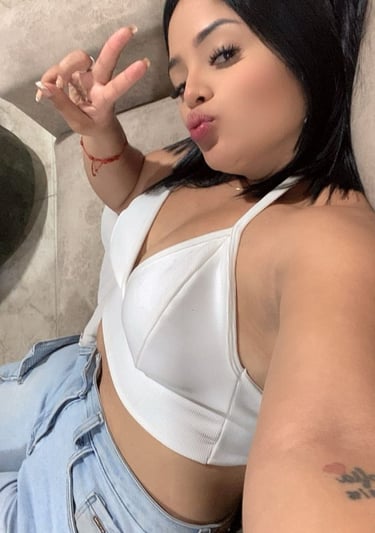 a woman with a white bra top and jeans