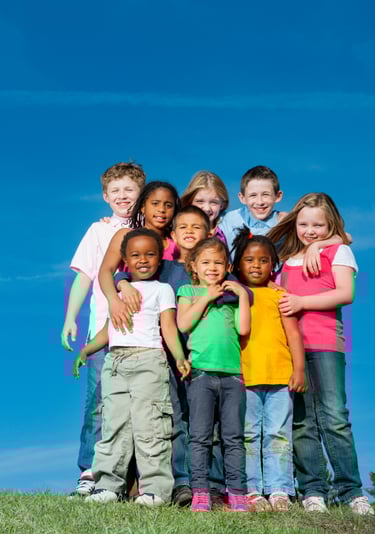 Colorful group of children on a hilltop