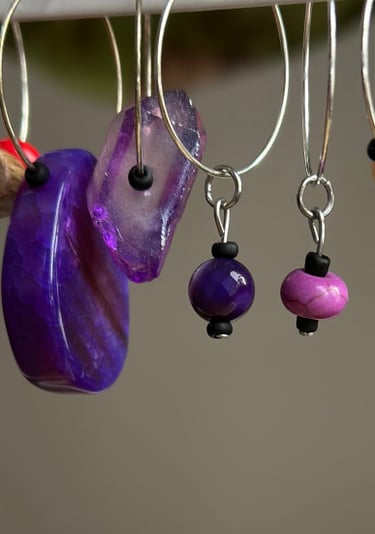 Rosevale Accessories handmade gemstone wine charms on jewelry display