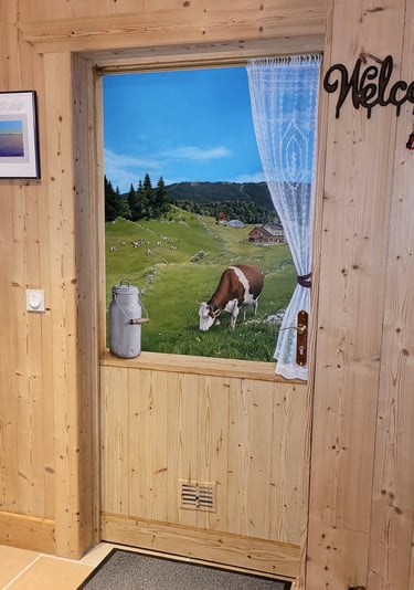 Trompe-l'oeil sur une porte intérieure quasi invisible. Faux bois, paysage, rideau, vaches, pot lait