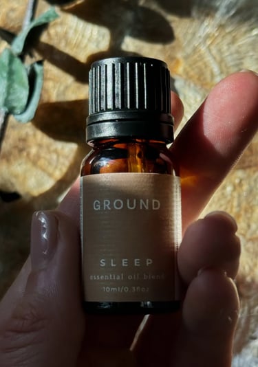 Sleep Essential Oil held in the palm of hand, close up shot