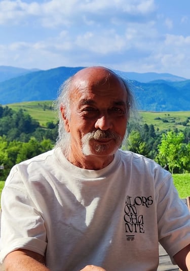 a man sitting at a table with a cup of coffee
