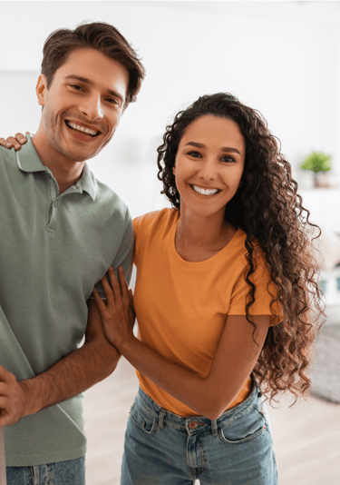 Young couple at the entrance to their home
