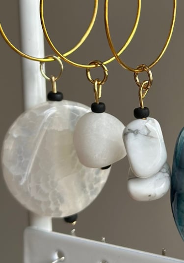 Rosevale Accessories handmade gemstone wine charms on jewelry display