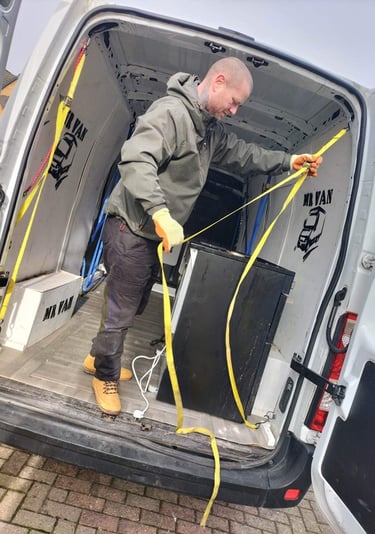 a man loading the back of a van