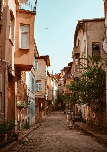 a sugar baby sitting on a bench in a city