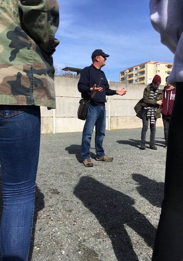 Andrew White At the Berlin Wall memorial talking about the Cold War and the division of Berlin