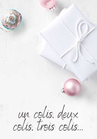 a white gift box with a pink ribbon and a pink ornament
