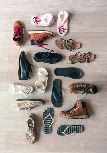 A collection of shoes, boots, sandals, and slippers