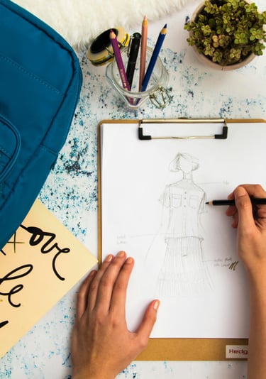 a person's hands are drawing a drawing of a human figure