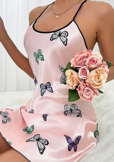 a woman in a pink dress holding a bouquet of roses