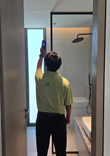 Engineer inspecting with thermal camera for leaks during villa inspection