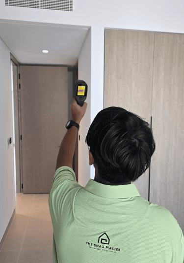Engineer inspecting with thermal camera for leaks during villa inspection