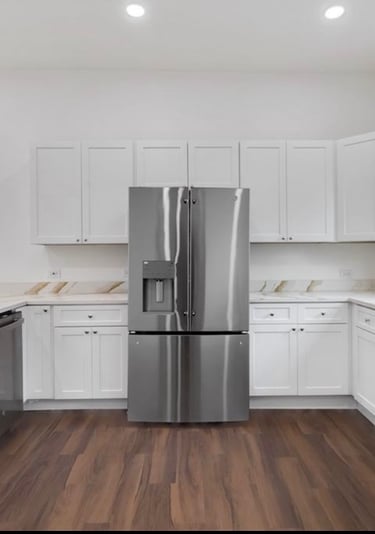 Custom kitchen featuring stainless steel fridge and modern cabinetry