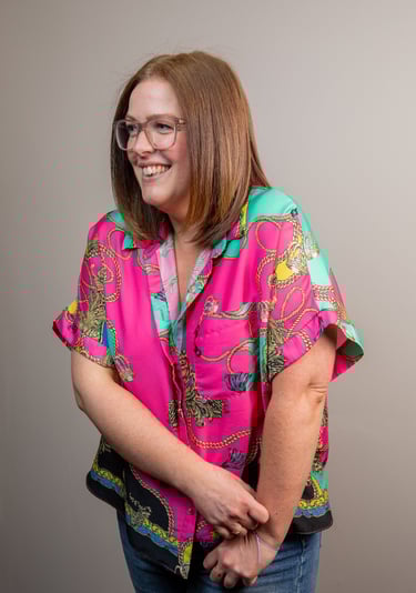 Photo of gabi, founder of the leopard  mind, looking to the left smiling.