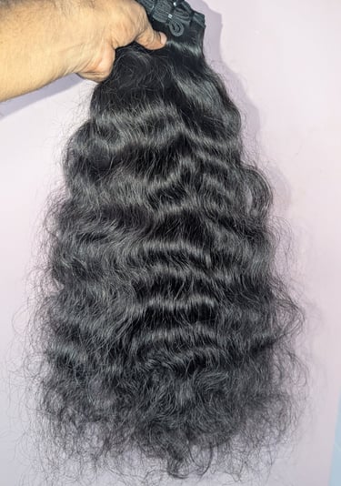 Wavy raw human hair bundles from Tanori Hair LLP prepared for wholesale export