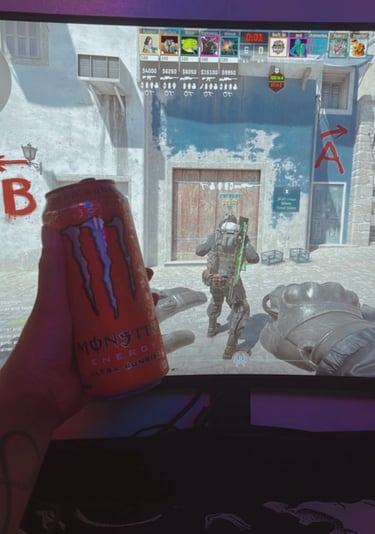 a person holding a can of monster energy drink