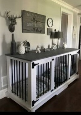 Custom white wooden double dog kennel furniture with a grey tabletop and black iron bars.
