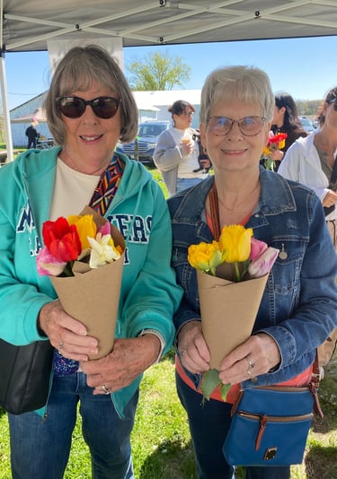 Ladies holding bouquets of tulips at the u-pick flower farm