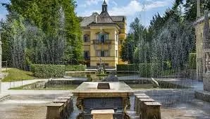 Lush green hedges and vibrant flower beds at the historic Mirabell Palace in Salzburg.