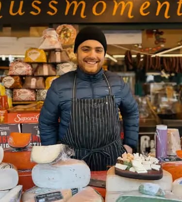 Local vendor showcasing authentic Austrian cheeses at a traditional market.