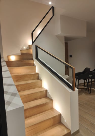 a staircase in oak with a steel and oak railing in a contemporary style