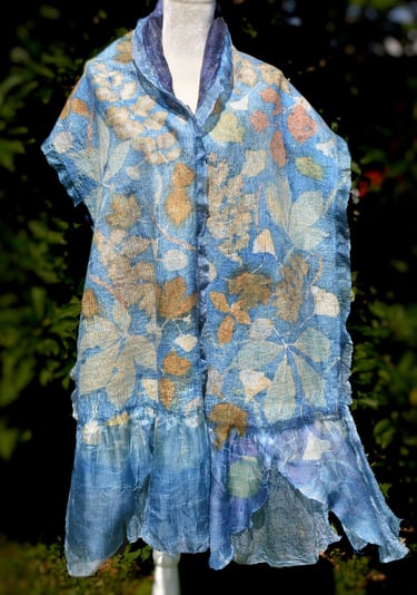 Handmade nuno felted blue silk scarf with botanical print leaf patterns on a mannequin.