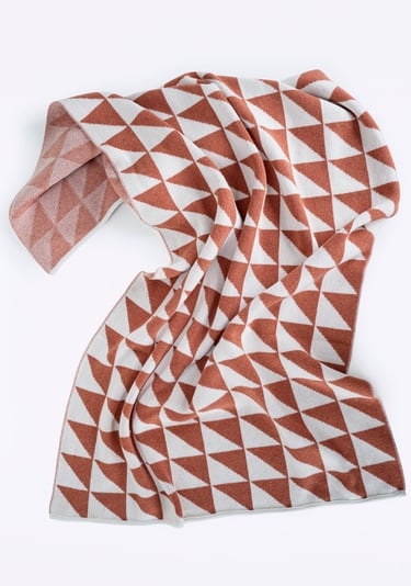 a blanket with a geometric pattern