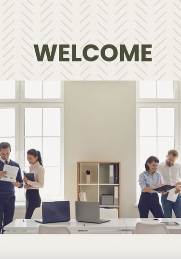 a group of people standing around a desk with a welcome sign