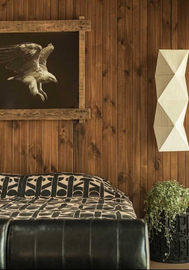 a bed with a large picture of a bird in the background