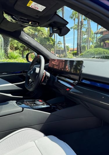 Luxury modern car interior with digital dashboard display and carbon fiber trim.