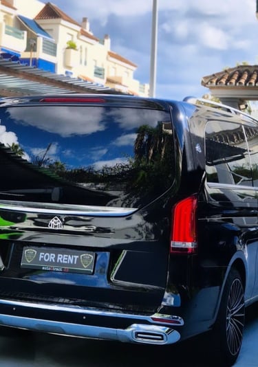 Luxury black Mercedes-Benz Maybach passenger van for rent parked in a residential driveway.