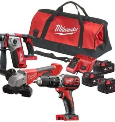 Milwaukee cordless power tool combo kit including rotary hammer, grinder, drill, batteries, and bag.