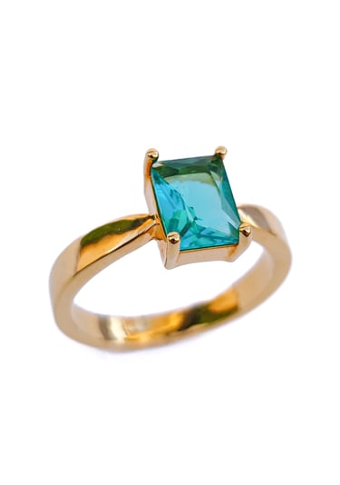 a ring with a green emerald colored stone