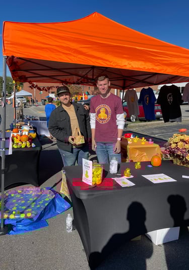 two men standing in front of a table with a table with a table cloth