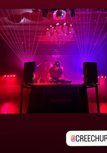 around a dj booth at a nightclub with instagram tag for creechur