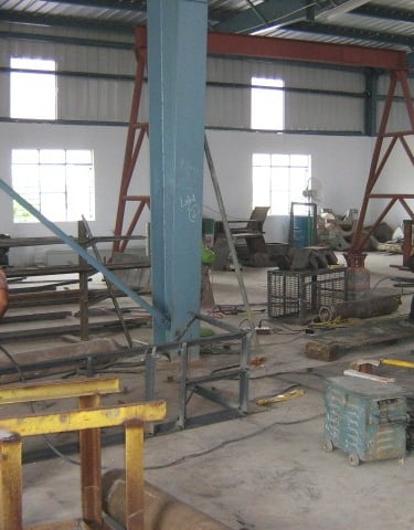 a man working on a machine in a factory