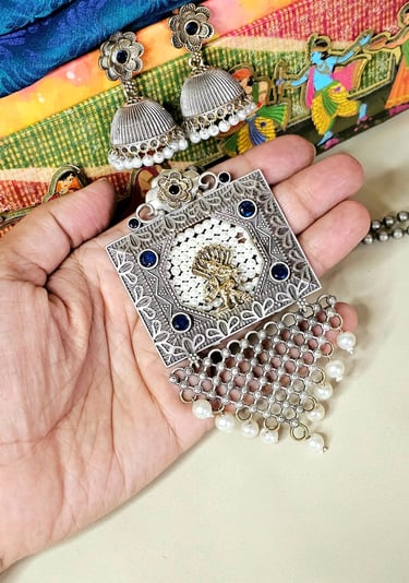 German Silver oxidized set with pearl detailing from Iridezza Jaipur Edit collection.