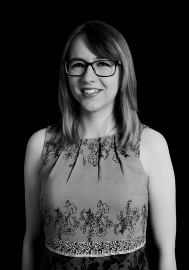 A black and white photo of Eloise, a woman in glasses and a dress.