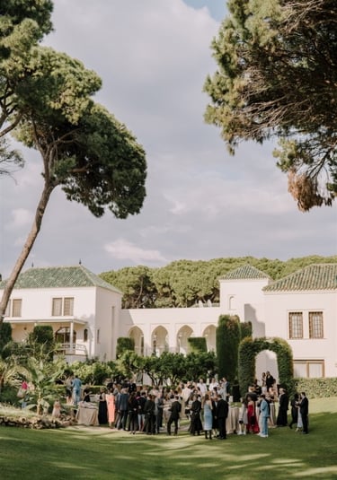 Garden event at Villa El Rincon with guests gathered among lush greenery