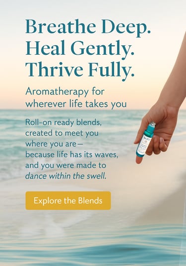 a person holding an essential oil roller bottle by the ocean
