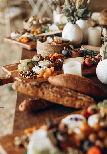 a table with a variety of cheeses and other foods