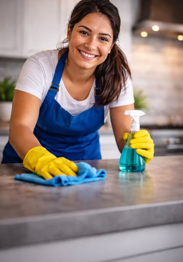Cleaning professional using spray bottle and gloves representing cleaning service business