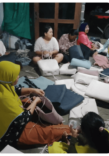 Group of artisans crafting handmade woven plastic bags together at Craftvitas Indonesia production area.