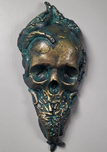 Bronze Cthulhu plaque. A skull with tentacles growing out of it. Teeth grow out of the tentacles to form the bottom jaw.