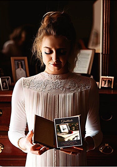 Young woman reading personal development journal
